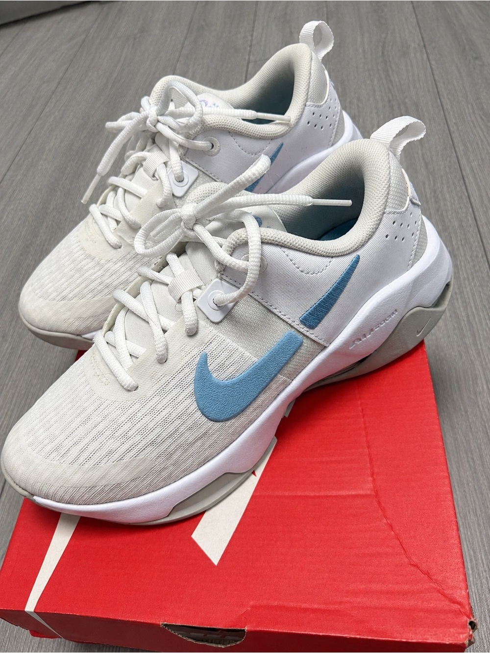 Nike Women's White Athletic Sneakers with Light Blue Swoosh